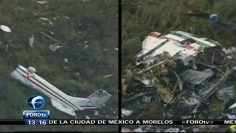 In this video frame grab image taken from Televisa's Forotv via APTN, the wreckage of a helicopter carrying Mexico's Interior Minister Francisco Blake Mora is seen in a mountainous area southeast of Mexico City.